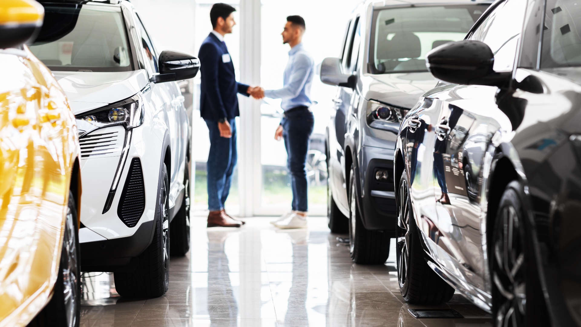Car Loan Pre-Approval in Australia Customer shaking hands with a car salesperson in a showroom